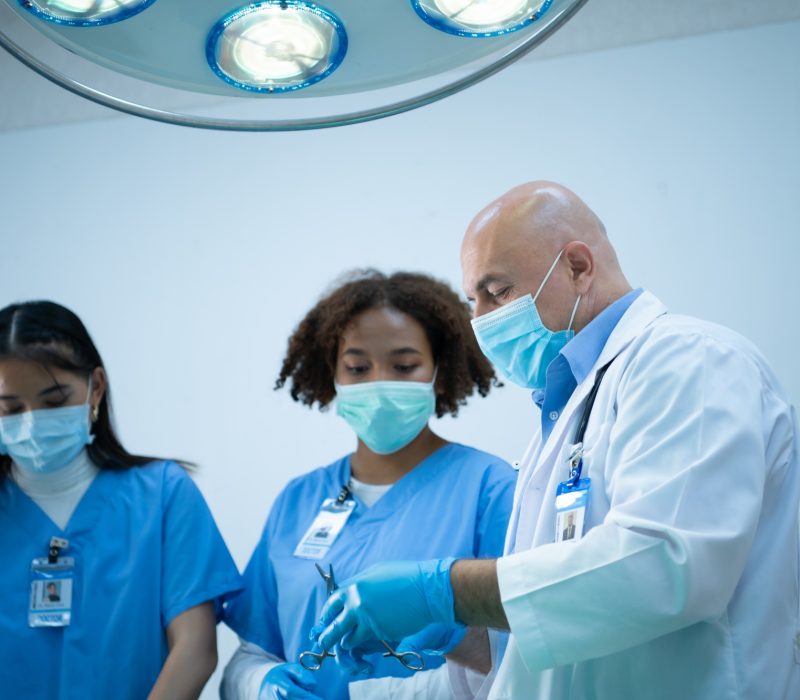 A medical professor is teaching surgery to medical students working