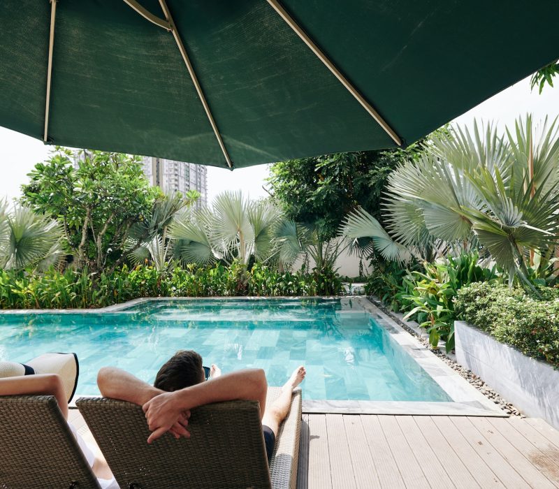 couple-pending-time-by-secluded-swimming-pool.jpg